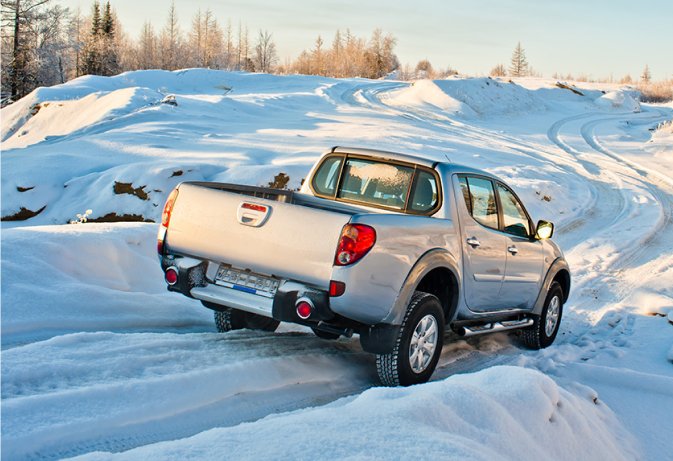 Car driving on a snowy road.